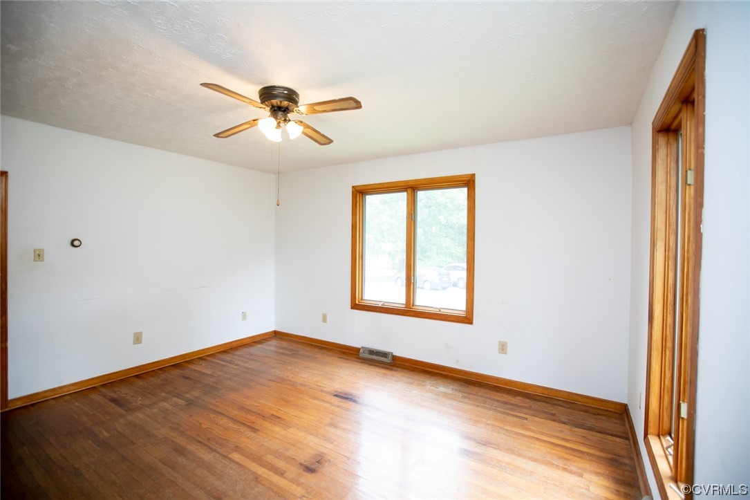 71 Spillman Road Farmville, VA 23901 - Photo 5 of 48 an empty room with windows and fan