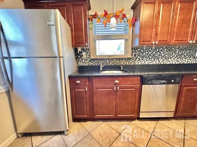 a kitchen with a refrigerator and a window