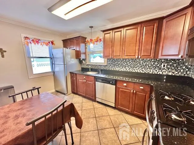 a kitchen with stainless steel appliances granite countertop a stove a sink dishwasher and a microwave