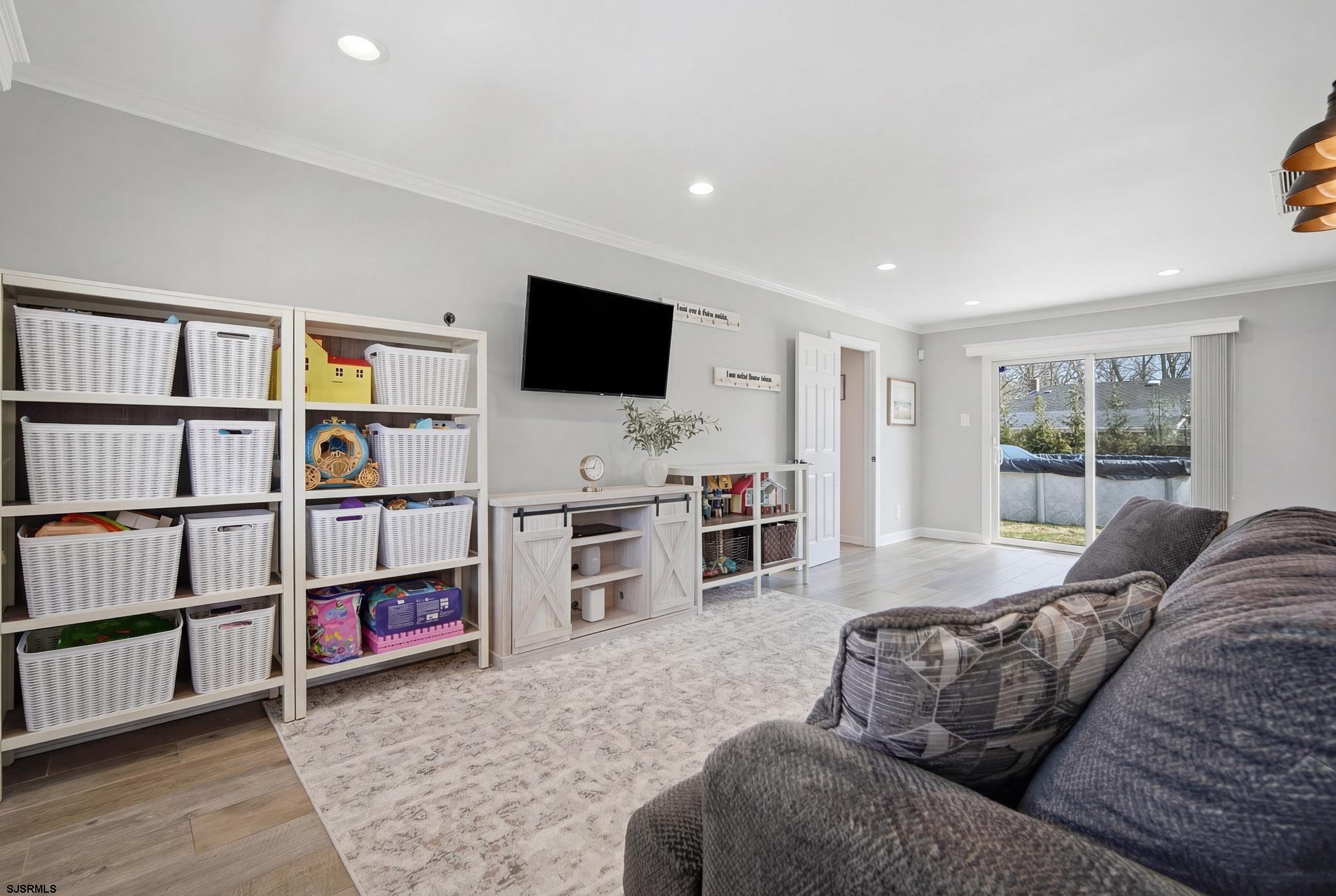2104 Grove Road Northfield, NJ 08225 - Photo 13 of 33 a living room with furniture and a flat screen tv