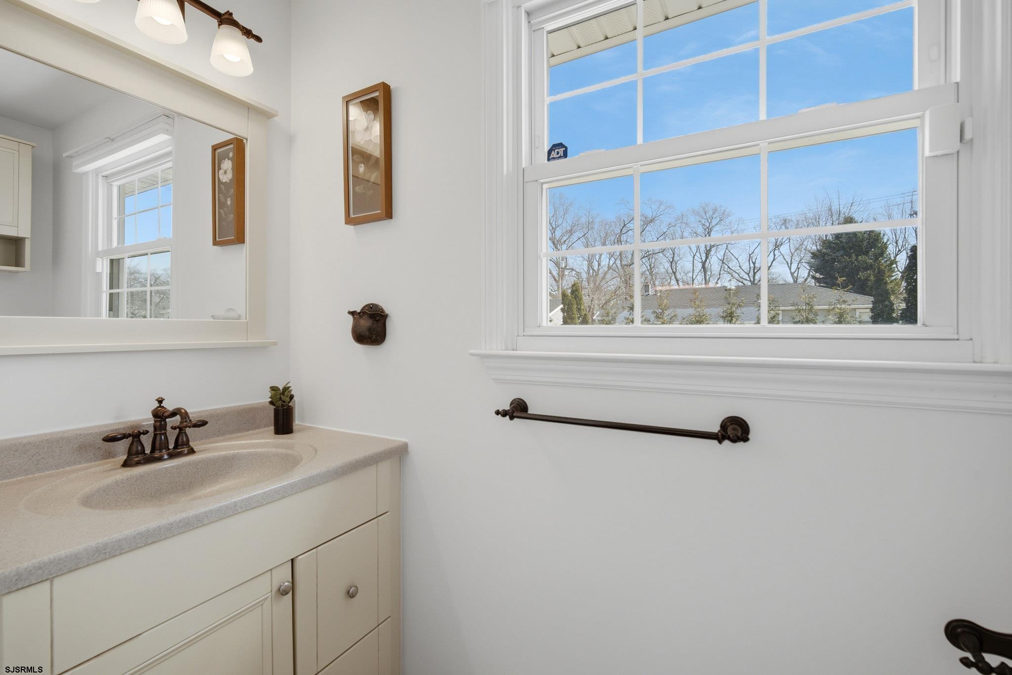 2104 Grove Road Northfield, NJ 08225 - Photo 16 of 33 a bathroom with a sink and a mirror