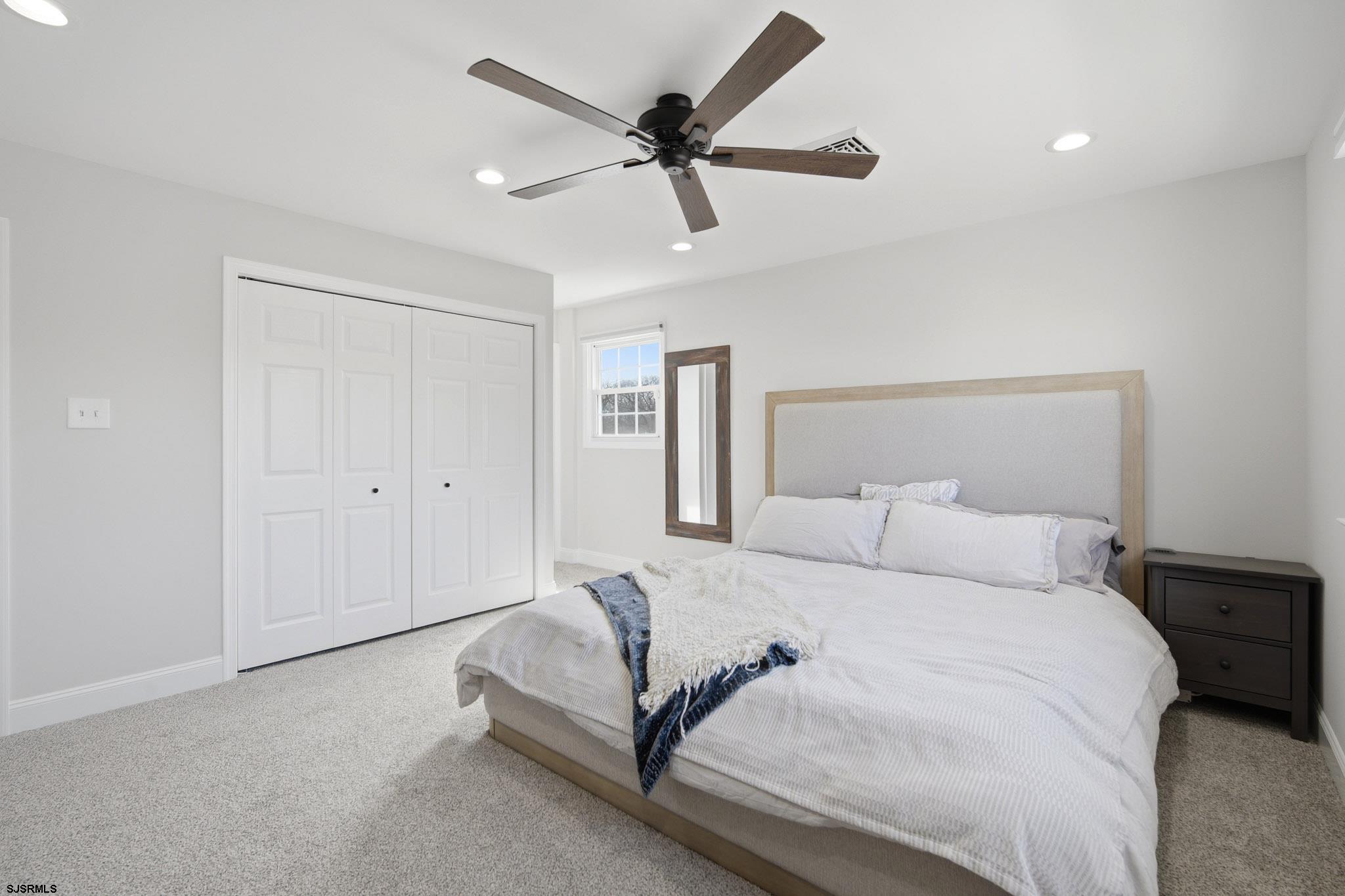 2104 Grove Road Northfield, NJ 08225 - Photo 22 of 33 a bedroom with a bed and a ceiling fan