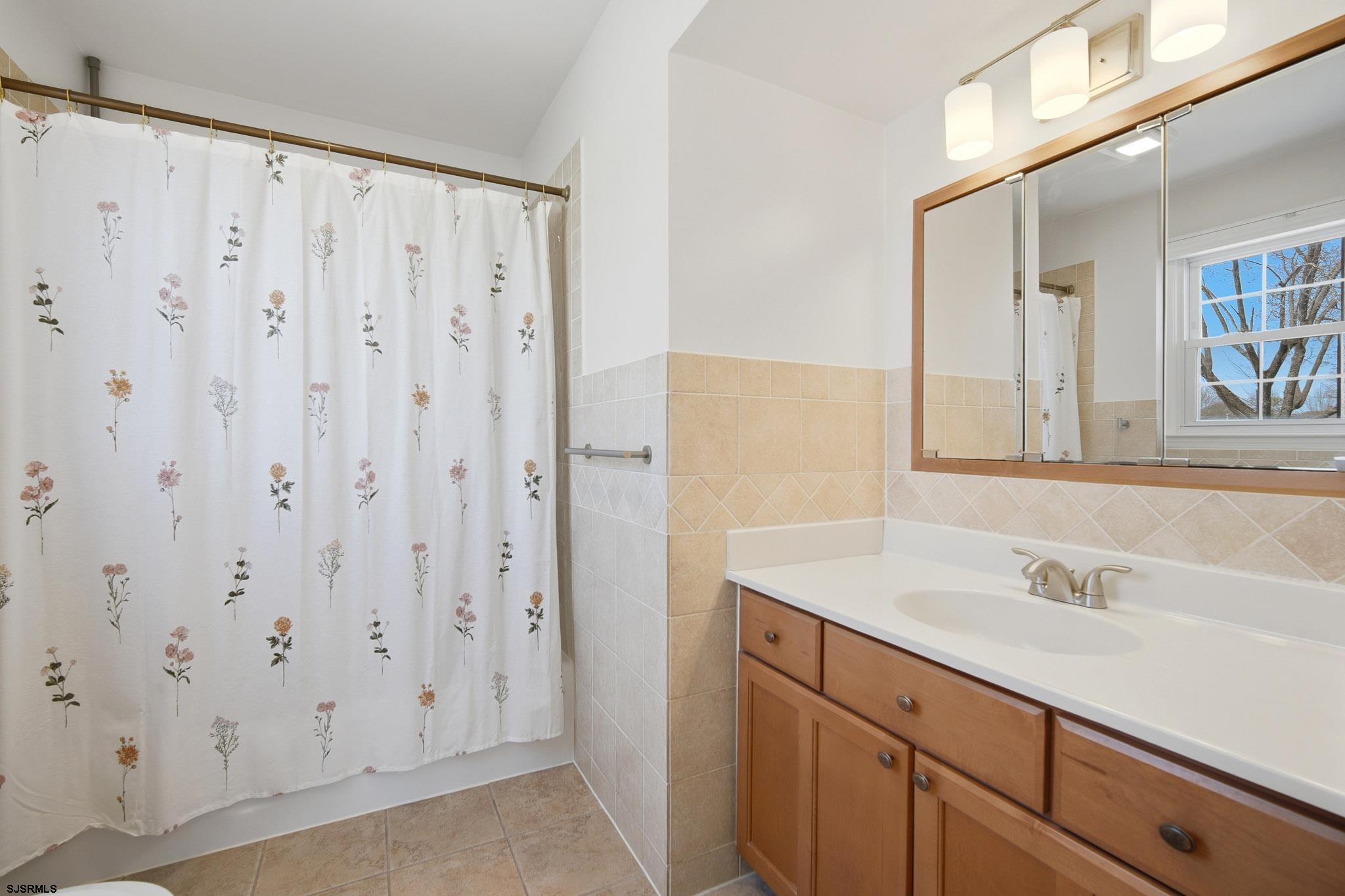 2104 Grove Road Northfield, NJ 08225 - Photo 26 of 33 a bathroom with a sink and a mirror