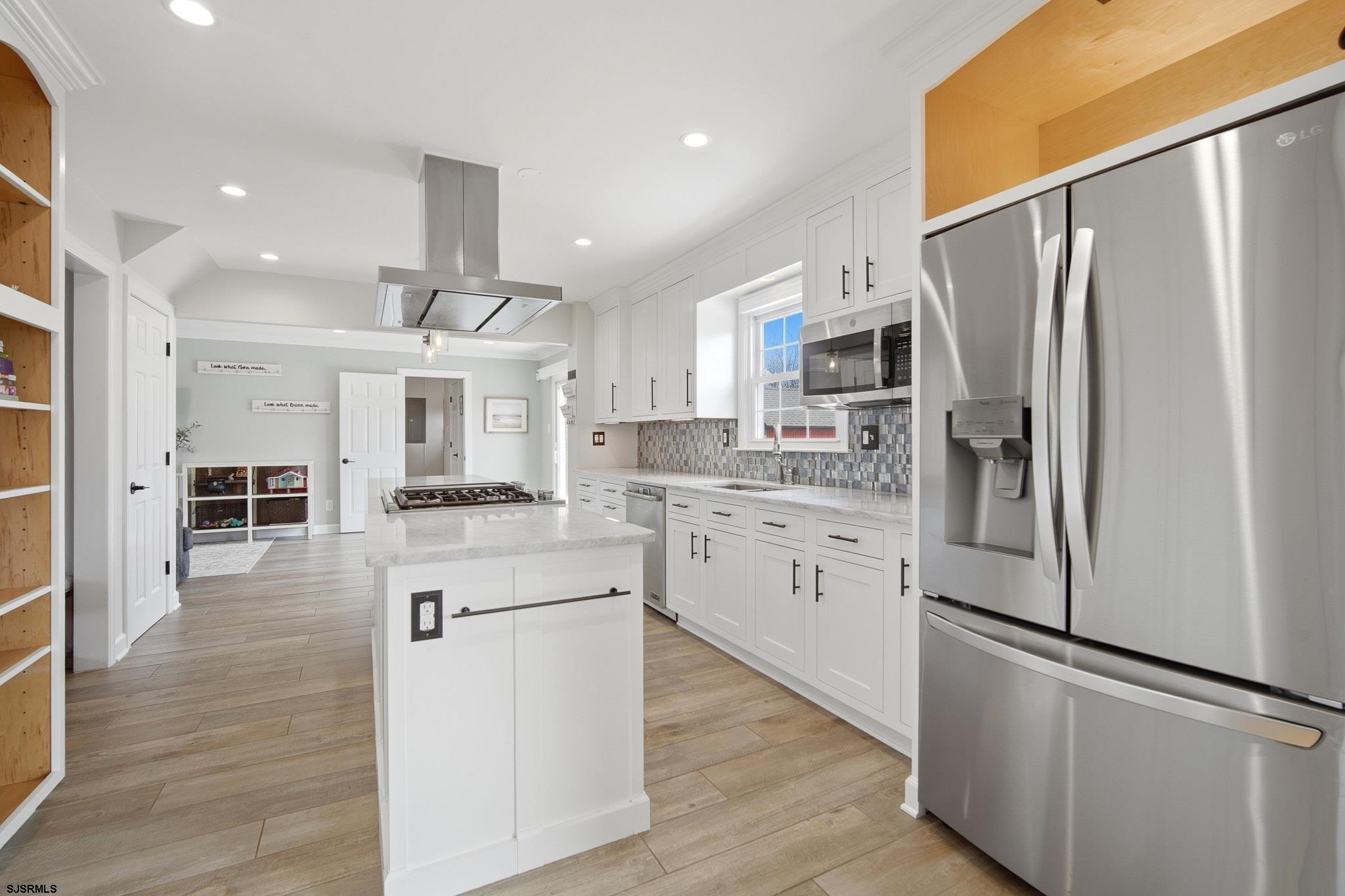 2104 Grove Road Northfield, NJ 08225 - Photo 7 of 33 a kitchen with stainless steel appliances a refrigerator sink and cabinets