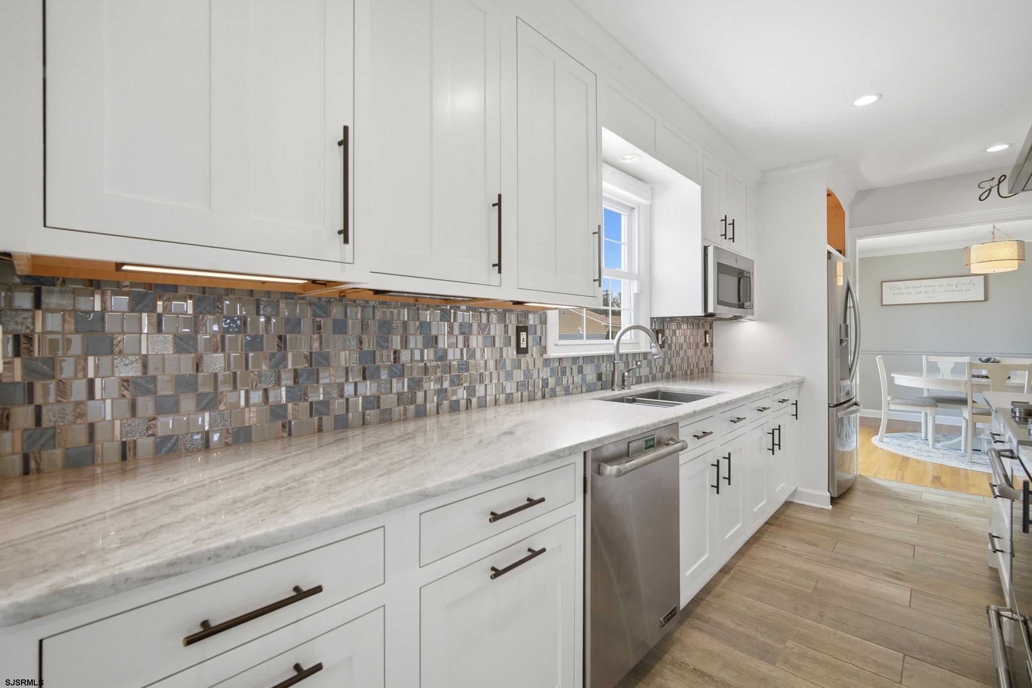 2104 Grove Road Northfield, NJ 08225 - Photo 8 of 33 a kitchen with granite countertop white cabinets and white appliances