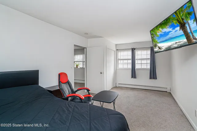 a view of a room with window and lounge chair