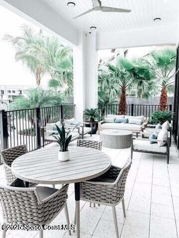 2750 Bosque Circle, Unit 304 Melbourne, FL 32940 - Photo 15 of 18 a view of a patio with table and chairs and potted plants