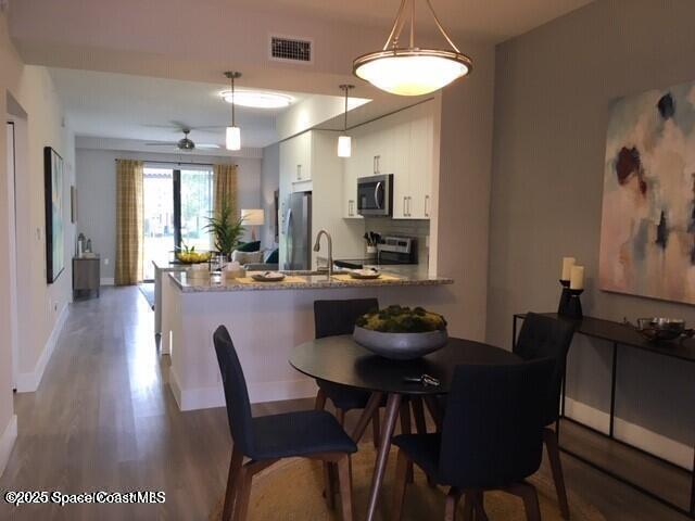 2750 Bosque Circle, Unit 304 Melbourne, FL 32940 - Photo 5 of 18 a dining room with furniture and window