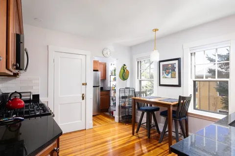 a view of a dining room with furniture and a window