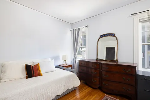 a bedroom with a bed and a dresser