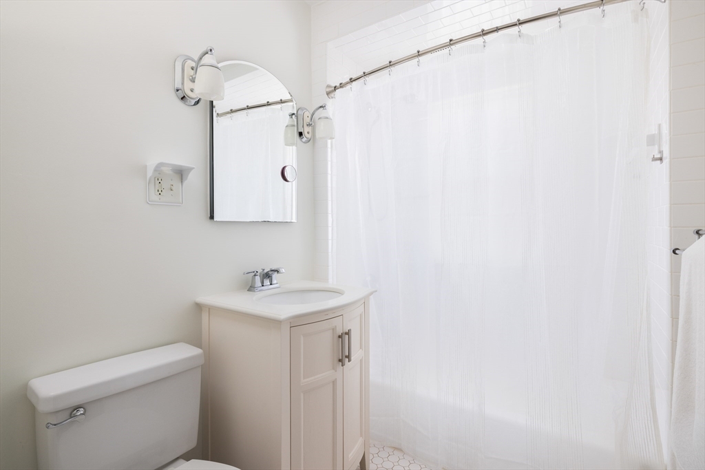 71 Congreve Street, Unit 2 Boston, MA 02131 - Photo 9 of 12 a bathroom with a sink a toilet and a mirror