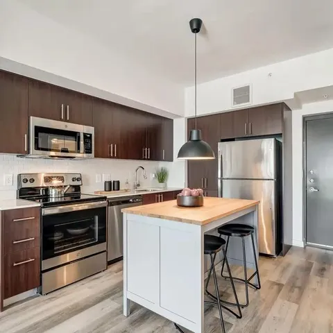 a kitchen with a stove a sink and a refrigerator