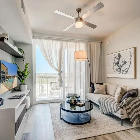 a living room with furniture and a large window