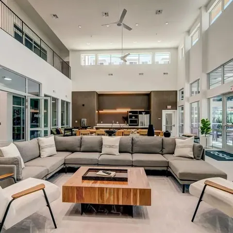 a living room with furniture and kitchen view