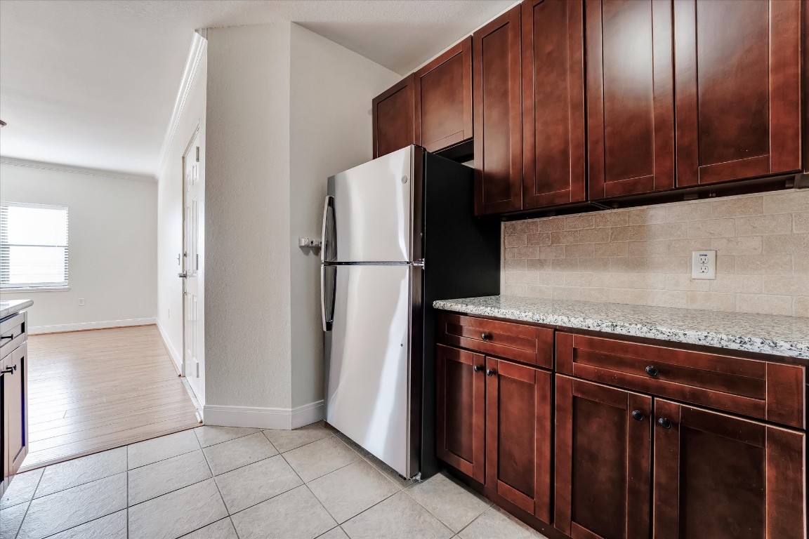 10102 Neuens Road, Unit A103 Houston, TX 77080 - Photo 9 of 23 a kitchen with stainless steel appliances granite countertop a refrigerator and a sink