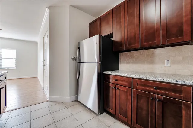a kitchen with stainless steel appliances granite countertop a refrigerator and a sink