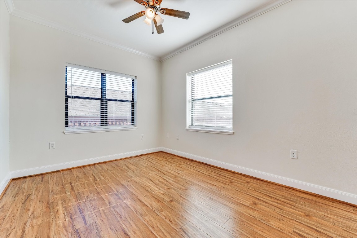 10102 Neuens Road, Unit A103 Houston, TX 77080 - Photo 10 of 23 a view of an empty room with wooden floor and a window