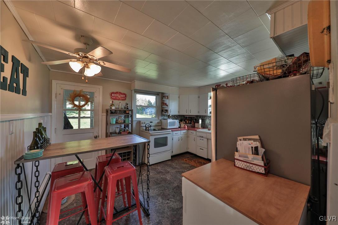 622 Hahn Road Nazareth, PA 18064 - Photo 21 of 37 a kitchen with a refrigerator a stove a dining table and chairs with wooden floor