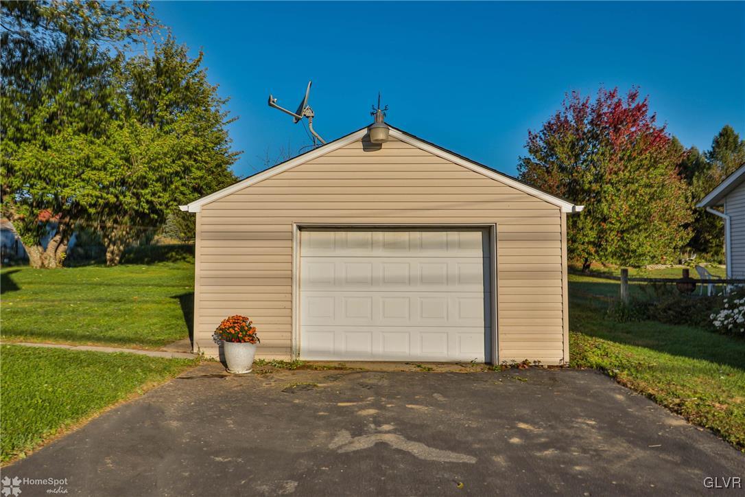622 Hahn Road Nazareth, PA 18064 - Photo 8 of 37 a front view of a house with a yard and garage