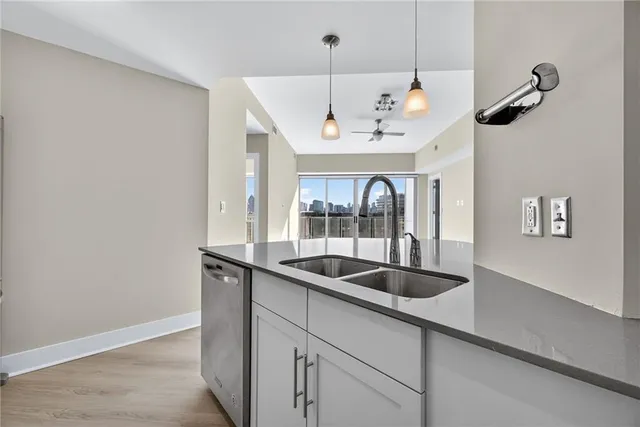 a kitchen with a sink a counter space and cabinets