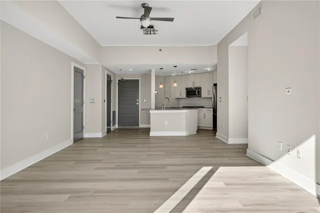 a view of a kitchen with a sink and cabinets