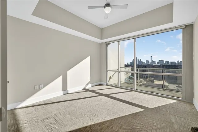 a view of a living room with a floor to ceiling window and an outdoor kitchen