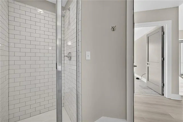 a bathroom with a double vanity sink mirror and shower