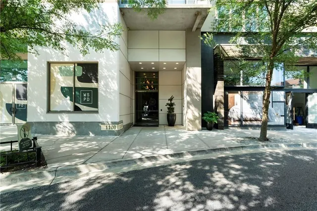 a front view of a house with a yard and glass windows