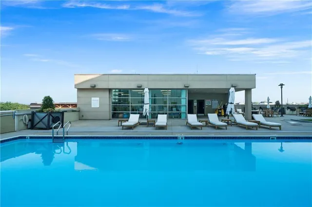 a view of a swimming pool with outdoor seating