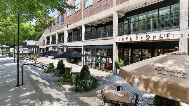 a view of a roof deck with table and chairs