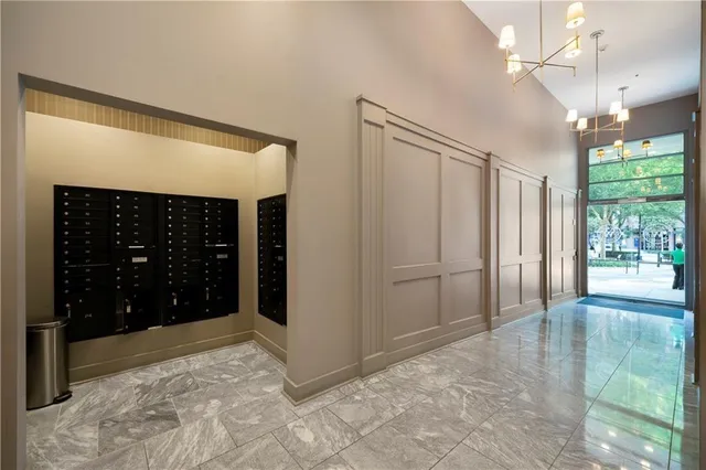 a view of a hallway with wooden floor and windows