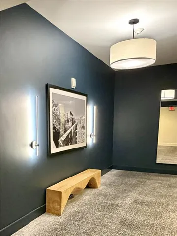 a bedroom with a bed and a painting on the wall