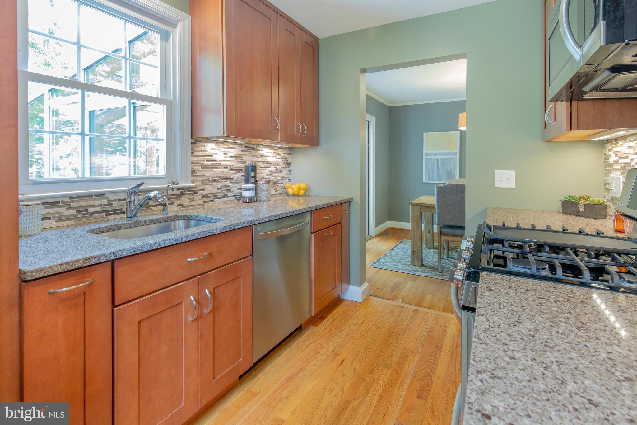 9105 Flower Avenue Silver Spring, MD 20901 - Photo 12 of 30 a kitchen with sink stove and cabinets