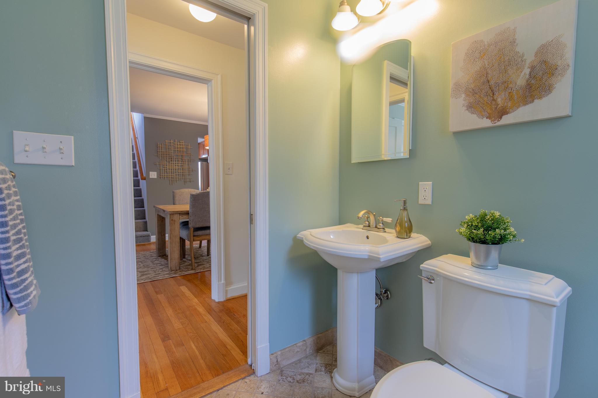 9105 Flower Avenue Silver Spring, MD 20901 - Photo 16 of 30 a bathroom with a sink a toilet and mirror