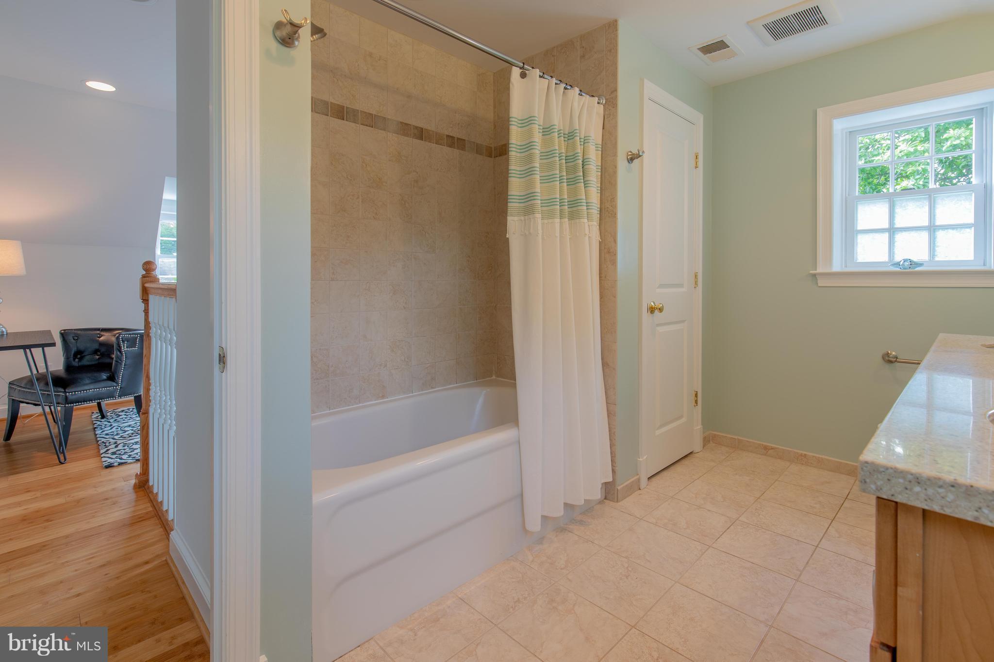 9105 Flower Avenue Silver Spring, MD 20901 - Photo 25 of 30 a bathroom with a bathtub and a shower