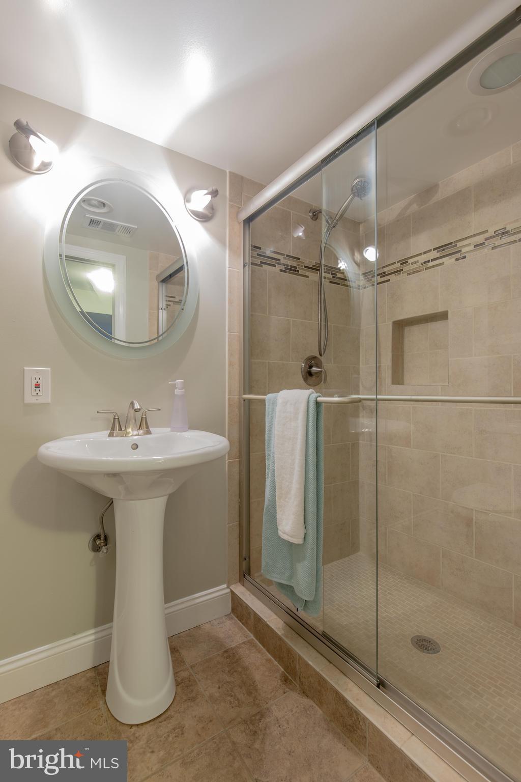9105 Flower Avenue Silver Spring, MD 20901 - Photo 30 of 30 a bathroom with a sink a mirror a vanity and shower