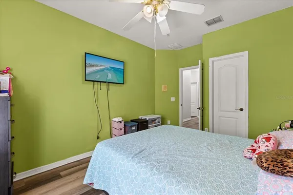 a bedroom with a bed and a chandelier
