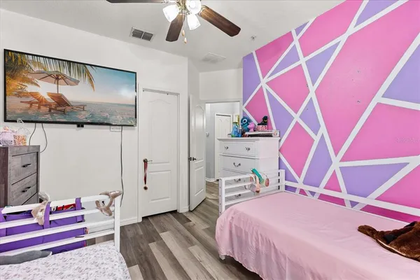 a bedroom with a bed and wooden floor