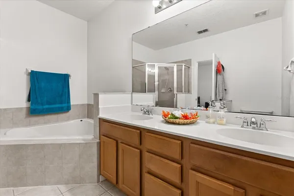 a bathroom with a bathtub sink and mirror