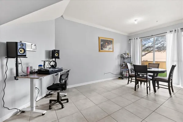 a view of a workspace with furniture and a window