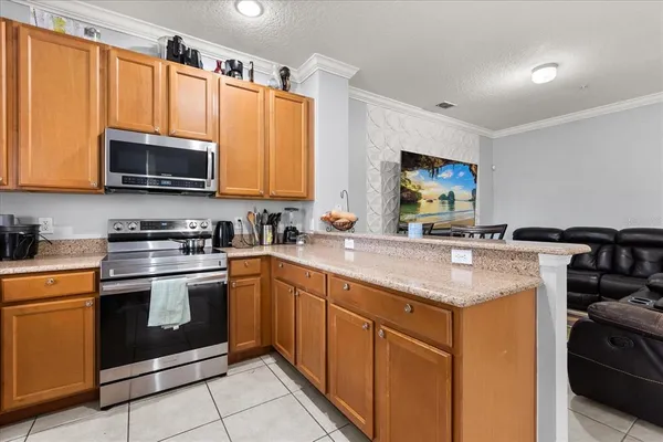 a kitchen with stainless steel appliances a stove sink microwave and cabinets