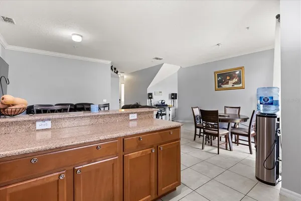 a view with kitchen island a sink table and chairs