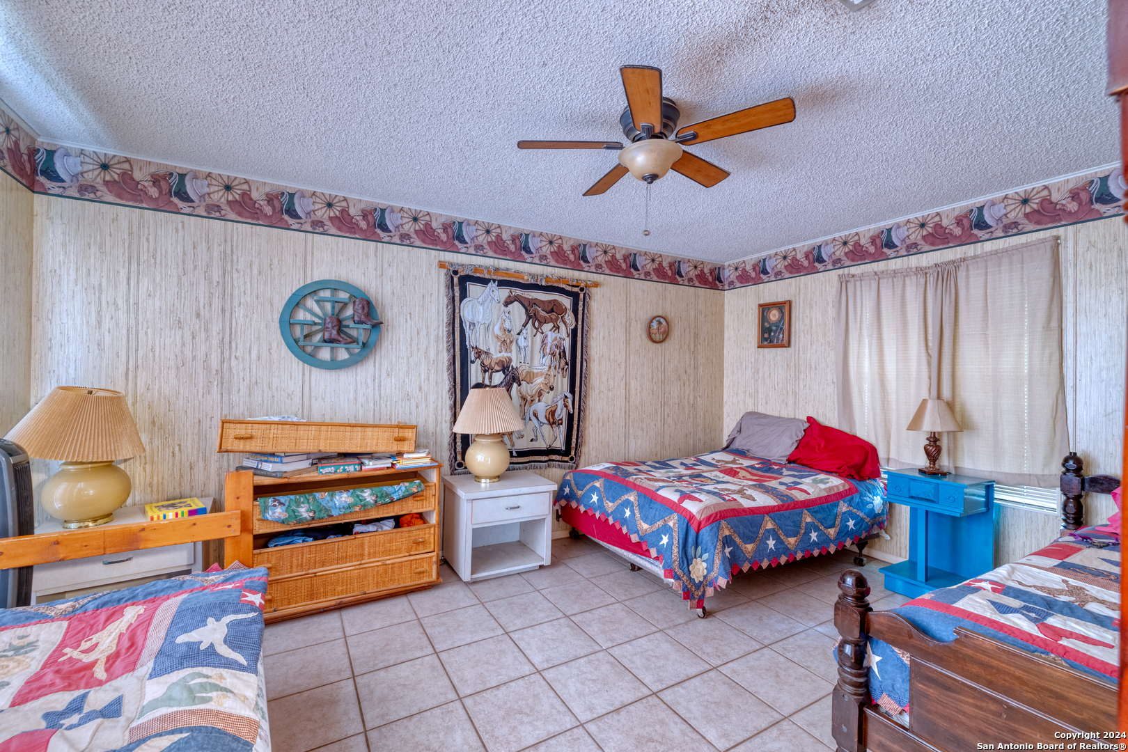 2227 Mill Creek Road Leakey, TX 78873 - Photo 14 of 20 a bedroom with a bed and a chandelier
