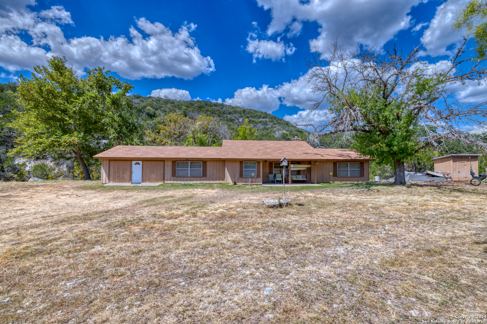 2227 Mill Creek Road Leakey, TX 78873 - Photo 2 of 20 a front view of a house with a garden