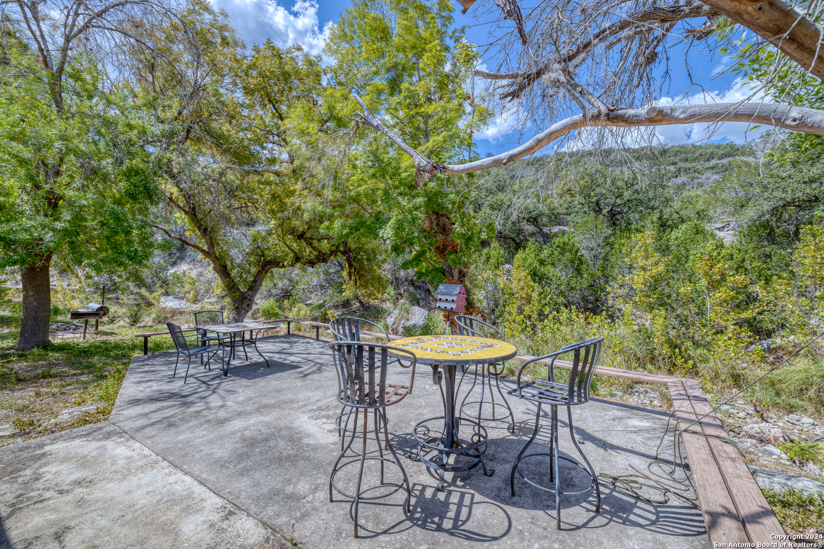 2227 Mill Creek Road Leakey, TX 78873 - Photo 4 of 20 a view of a table and chairs in the patio