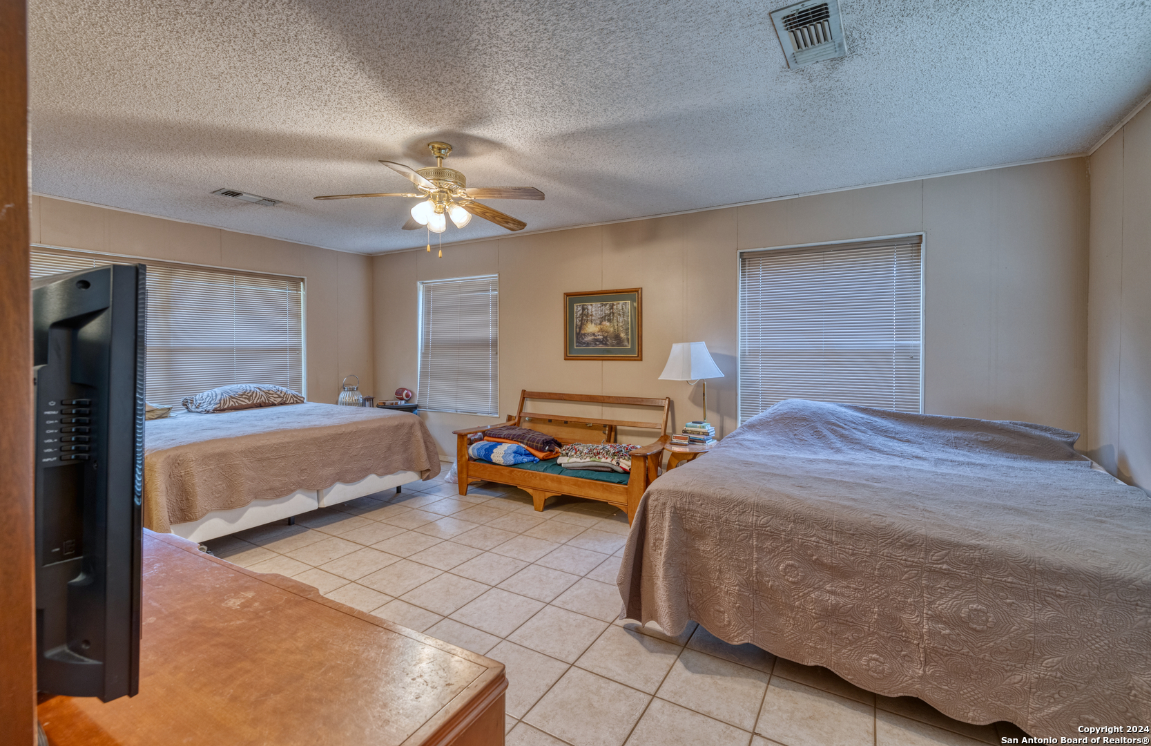 2227 Mill Creek Road Leakey, TX 78873 - Photo 10 of 20 a bedroom with a bed and a chandelier
