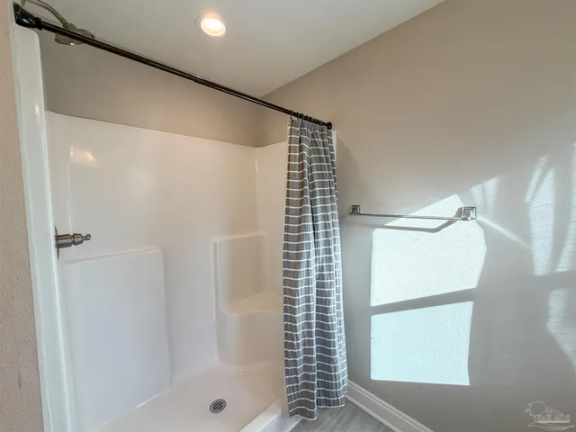 a bathroom with a shower and a glass door