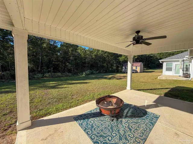 a view of a porch with furniture and garden