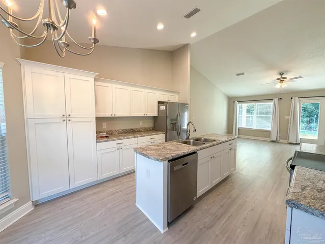 a kitchen with a stove a sink and a refrigerator