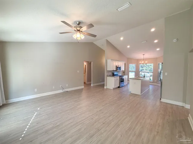 a view of a kitchen with a sink and a refrigerator